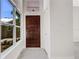 Light-filled entryway featuring a wood door and tile flooring at 1608 80Th Nw St, Bradenton, FL 34209