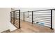 Modern metal railing and hardwood floor overlook living area at 1608 80Th Nw St, Bradenton, FL 34209