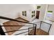 Modern staircase with metal railing offering a view of the main floor at 1608 80Th Nw St, Bradenton, FL 34209