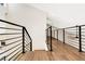 Modern staircase with sleek metal railing and hardwood floors at 1608 80Th Nw St, Bradenton, FL 34209