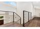 Modern staircase with sleek metal railing and hardwood floors at 1608 80Th Nw St, Bradenton, FL 34209