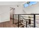 Upstairs hallway with modern railing overlooking main floor at 1608 80Th Nw St, Bradenton, FL 34209