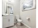 Modern powder room with white vanity and gray tile flooring at 16135 Paynes Mill Dr, Bradenton, FL 34211