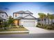 Two-story house with gray siding, landscaping, and a two-car garage at 16135 Paynes Mill Dr, Bradenton, FL 34211