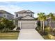 Two-story house with gray siding, brown roof, and a two-car garage at 16135 Paynes Mill Dr, Bradenton, FL 34211