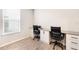 Home office with two desks, chairs, and plenty of natural light at 16135 Paynes Mill Dr, Bradenton, FL 34211