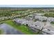 Aerial view of a community with houses, pools, and a lake at 16439 Slate Pl, Bradenton, FL 34211