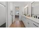 Modern bathroom features double vanity and a view into bedroom at 16439 Slate Pl, Bradenton, FL 34211