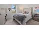 Cozy bedroom with large window, plush bedding, and a desk area at 16439 Slate Pl, Bradenton, FL 34211