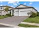 Modern two-car garage home with paver driveway and landscaping at 16439 Slate Pl, Bradenton, FL 34211