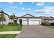 Modern two-car garage home with landscaped lawn at 16439 Slate Pl, Bradenton, FL 34211