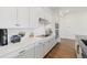 Modern kitchen with white cabinets, quartz countertops, and stainless steel appliances at 16439 Slate Pl, Bradenton, FL 34211