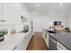 Modern kitchen with white cabinets, a large island, and stainless steel appliances at 16439 Slate Pl, Bradenton, FL 34211