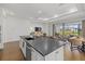 Open concept kitchen with large island and dark countertops at 16439 Slate Pl, Bradenton, FL 34211