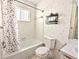 Bathroom with shower/tub combo, floral wallpaper and polka dot shower curtain at 2036 Canal Dr # M33, Bradenton, FL 34207