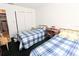 Bedroom with two twin beds, a dresser, and sliding closet doors at 2036 Canal Dr # M33, Bradenton, FL 34207