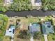 Aerial view showing canal-front home with fenced backyard and pool at 2146 Como St, Port Charlotte, FL 33948