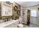 Updated bathroom with subway tile shower and farmhouse style vanity at 2146 Como St, Port Charlotte, FL 33948