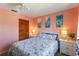 Cozy bedroom with a queen-size bed and coral-colored walls at 2146 Como St, Port Charlotte, FL 33948