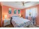 Bedroom with queen bed, light coral walls, and floral bedding at 2146 Como St, Port Charlotte, FL 33948