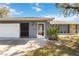 House exterior featuring a gray facade and a white door at 2146 Como St, Port Charlotte, FL 33948