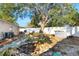 A backyard with a stone pathway, mature trees, and a white fence at 2416 Amherst Ave, Bradenton, FL 34207