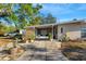 Mid-century modern home with covered entryway and potted plants at 2416 Amherst Ave, Bradenton, FL 34207