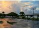 Empty parking lot reflecting sunset colors in puddles at 2416 Amherst Ave, Bradenton, FL 34207