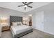 Bright bedroom with gray upholstered bed and ceiling fan at 2471 Midnight Pearl Dr, Sarasota, FL 34240