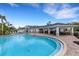 Community pool with plenty of seating and a covered area at 2471 Midnight Pearl Dr, Sarasota, FL 34240