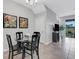 Elegant dining area with glass table and four black chairs at 2471 Midnight Pearl Dr, Sarasota, FL 34240