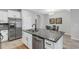 Kitchen boasts stainless steel appliances and large granite island at 2471 Midnight Pearl Dr, Sarasota, FL 34240