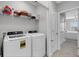 Laundry room with washer, dryer, and shelving at 2471 Midnight Pearl Dr, Sarasota, FL 34240