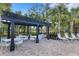 Relaxing pergola with tables and chairs near the pool at 2471 Midnight Pearl Dr, Sarasota, FL 34240