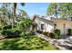 Side view of a condo with a walkway, landscaping, and attached garage at 3105 Sandleheath # 1, Sarasota, FL 34235