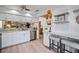 Modern kitchen with white cabinets, stainless steel appliances, and light wood floors at 3105 Sandleheath # 1, Sarasota, FL 34235