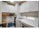 Bright laundry room with washer, dryer, and ample cabinet space at 3105 Sandleheath # 1, Sarasota, FL 34235