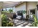 Relaxing patio with seating area, grill, and lush greenery at 3105 Sandleheath # 1, Sarasota, FL 34235