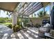 Covered patio with seating area and wooden pergola at 3105 Sandleheath # 1, Sarasota, FL 34235