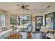 Sunroom with canal view, wicker furniture, and tiled floor at 3105 Sandleheath # 1, Sarasota, FL 34235