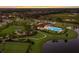 Community pool, clubhouse, and playground with a scenic pond at 3324 Big Sky Way, Lakewood Ranch, FL 34211