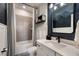 Bathroom with grey tile, tub, and modern vanity at 3324 Big Sky Way, Lakewood Ranch, FL 34211