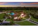 Community clubhouse with pool and surrounding landscape at 3324 Big Sky Way, Lakewood Ranch, FL 34211