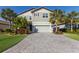 Two-story home with gray siding, a two-car garage, and lush landscaping at 3324 Big Sky Way, Lakewood Ranch, FL 34211