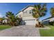 Two-story home with gray siding, two-car garage, and attractive landscaping at 3324 Big Sky Way, Lakewood Ranch, FL 34211