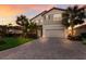 Two-story house with gray siding, brown roof, and a paved driveway at 3324 Big Sky Way, Lakewood Ranch, FL 34211