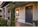 Inviting front porch with a dark door and yellow chairs at 3324 Big Sky Way, Lakewood Ranch, FL 34211