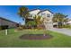 Landscaped front yard with lush tropical plants and a paved driveway at 3324 Big Sky Way, Lakewood Ranch, FL 34211