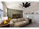 Mid-century modern living room with geometric wallpaper, ceiling fan, and comfortable seating at 3324 Big Sky Way, Lakewood Ranch, FL 34211