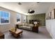 Bright and airy living room features mid-century modern furniture and geometric wallpaper at 3324 Big Sky Way, Lakewood Ranch, FL 34211